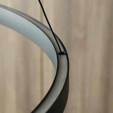 Close-up of 48-inch Fiama LED suspension light in matte black with minimalist circular design