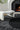 Eye Flower wool rug in Black, styled in a room