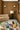 Caprice wool rug in Multi, styled in a room