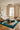 Aduma wool rug in Nuit, styled in a room