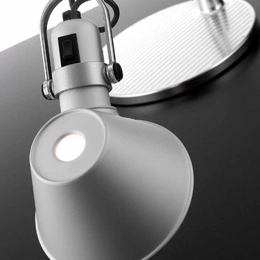 Artemide Tolomeo Classic LED desk lamp showing fully extended arm and focused task lighting