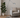 Tolomeo adjustable floor lamp beside modern beige armchair with plant, Italian LED lighting for living room