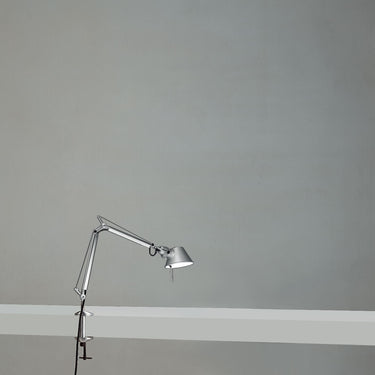 Artemide Tolomeo Micro LED table lamp with adjustable arm and aluminum finish on desk