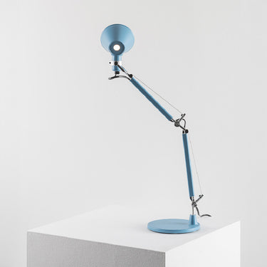 Artemide Tolomeo Micro matte light blue table lamp showing rotating shade and weighted base