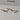 Trace Linear 5 chandelier with five curved bronze strands hung from a long ceiling plate, studio view