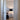 Modern Tripode G5 floor lamp with black ribbon shade and warm lighting