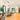 ET2 Unity looped pendant in an open kitchen and living area with wood floors and a wood front door
