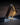 Lambda lamp by Teukho in Black lit on a wood desk