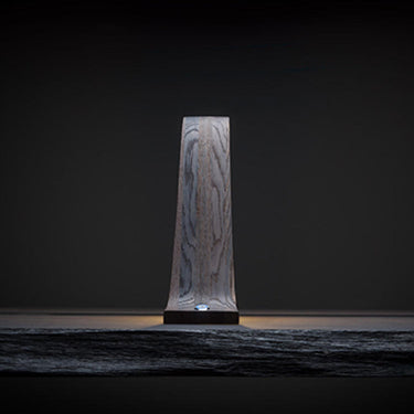 Lambda lamp by Teukho in Black, end-on profile on a dark surface