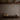 Astep Upglas T1 table lamp, on a low wooden bench