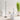 Black Moneta Medium floor lamp beside a white round table with a small table lamp and a stone