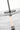 Shakkei Double X-Large Pendant by Sean Lavin in Clear Bronze, close view of the stem, the disc and the lit light tube at the center of the glass