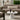 Sesa Short Accent lamp in Black glowing at medium brightness on an outdoor table