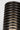Close-up of the Quoddy Small lamp in Dark Bronze, warm light glowing between the thin rings