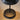 Round base of the black Tepa Short Accent table lamp on a warm tabletop
