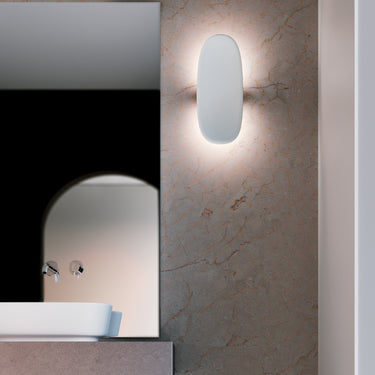 Penta Vela wall sconces beside a bathroom mirror