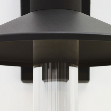 Close-up of Visual Comfort 700OWASHH Ash charcoal sconce clear cylinder diffuser and aluminum shade detail.