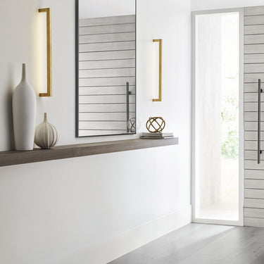 Natural brass vertical LED wall fixture suitable for living rooms, offices, and hospitality lighting projects
