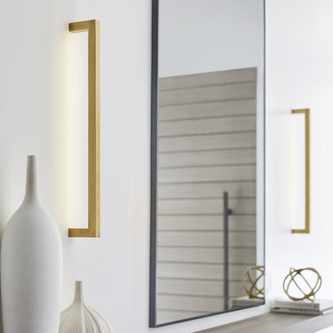 Decorative LED wall sconce with natural brass body for upscale residential and professional lighting design