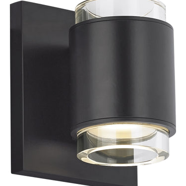 Black Voto round LED wall lamp, dimmable with a compatible dimmer switch, creating ambient light in a modern living room.