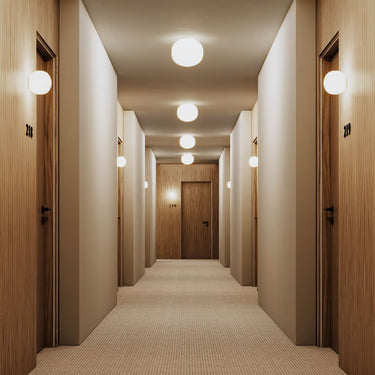 Glossy white globe wall sconce providing even 360-degree illumination, Lodes Volum wall lamp