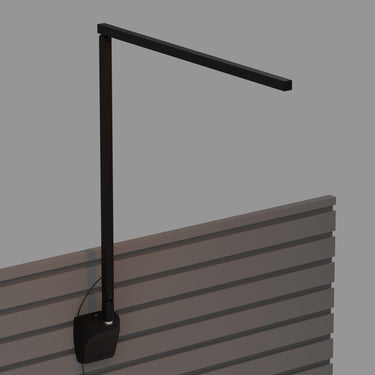 Sleek dimmable LED wall fixture with a flexible arm, ideal for a contemporary bedroom in matte black, slatwall mounting.