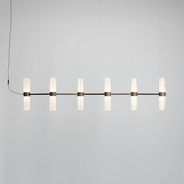 Zephyr linear suspension lamp by Artemide installed over a dining table