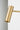 Close-up of the cylindrical shade of the Heron floor lamp in satin brass
