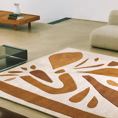 Alpha wool rug in Terracotta, styled in a room