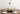 Artemide Miconos Gold pendant light with clear glass globe installed on top of a dining table