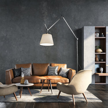 Artemide Tolomeo Mega LED floor lamp extending over a modern sofa