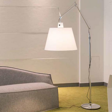 Artemide Tolomeo Mega Parchment LED floor lamp extending over modern sofa