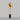 Pendulum floor lamp in bronze with a smoked glass shade on a black marble base, studio view