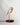 Daqiconcept Bird LED Dimmable Desk Lamp - Almond Beige illuminating a book on a bedside table