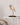 Warm, inviting light from Daqiconcept Bird LED Dimmable Desk Lamp - Almond Beige in a cozy reading nook