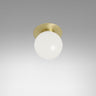 Small Mezzo flush light with a round opal glass globe and a satin brass backplate, studio view