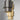 Close-up of two Ring pendants, one in bronze and one in satin brass, with brass interiors