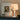 Acropolis table lamp on a console in front of framed abstract art