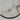 Close-up of the veined honed alabaster disc of an Anvers light in a bronze rim