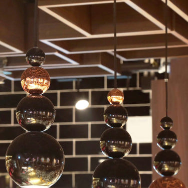 Designer bubble pendant light casting water-like shadows in modern living rooms