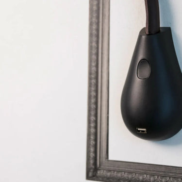 Elegant brown leather Innermost Cobra lamp with dimmable LED and convenient USB charging station.