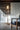 Penta Glo floor lamp, a glass sphere on a slim metal stand, lit in a living room