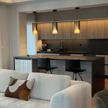 Penta Lit pendant lights hanging over a table