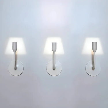 Sleek YOY LED wall fixture creating a unique projected light effect in office space.
