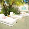 White Stand corner ottoman set beside a Cot twin daybed with a pink pillow on a sunlit terrace with palms