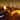 White modular benches and ottomans on a rooftop lounge lit by candles at night
