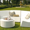 White Puck ottoman as a coffee table with a tea tray in front of a curved sectional on a lawn