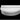 Studio view of a white Roll bolster resting along the back of a Moon Pad on a black background