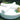 Two white Roll bolsters crossed on a round Sun Pad on a lawn with a tray and flowers
