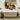 White Stand square vinyl ottoman used as a low table with a fruit basket and decor on top